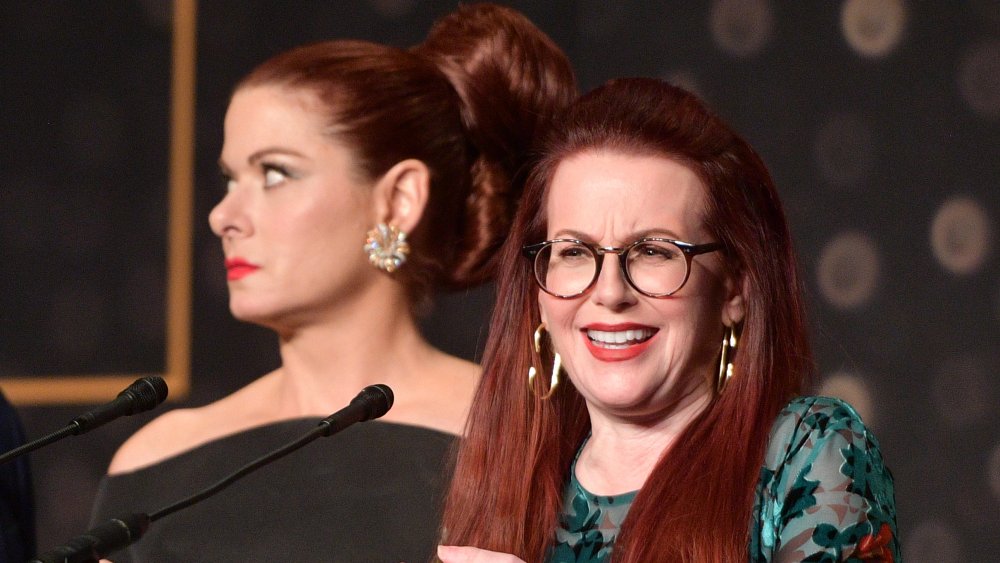 Debra Messing looking annoyed as Megan Mullally speaks