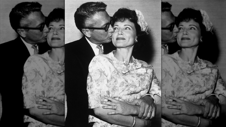 Allen Ludden kissing Betty White on the cheek on their wedding day.