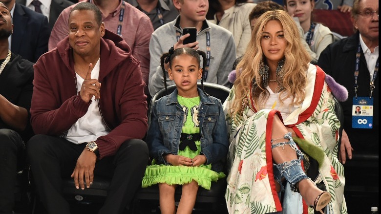 Jay-Z, Blue Ivy, and Beyoncé at sporting event