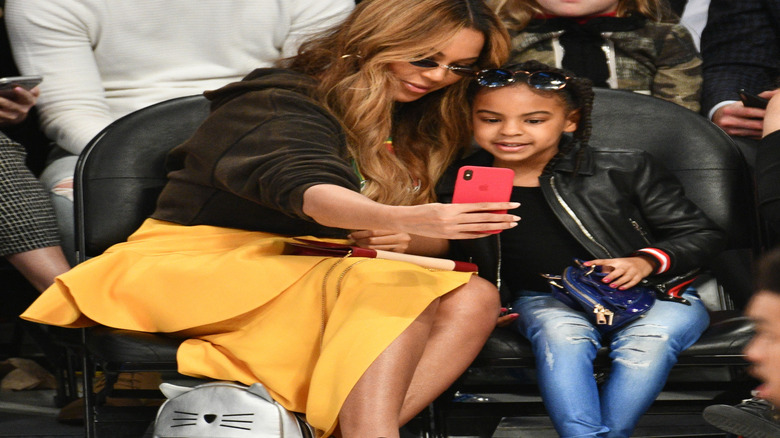 Beyonce sits courtside with Blue Ivy at a basketball game