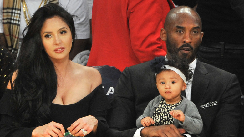Bianka Bryant sitting on Kobe Bryant's lap