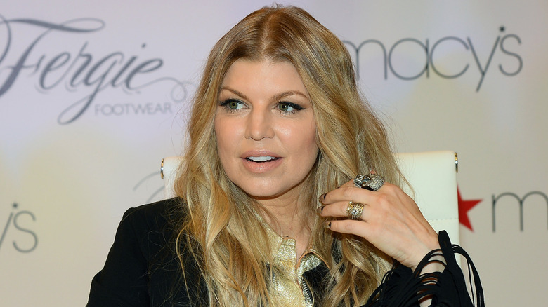 Fergie touching her hair.