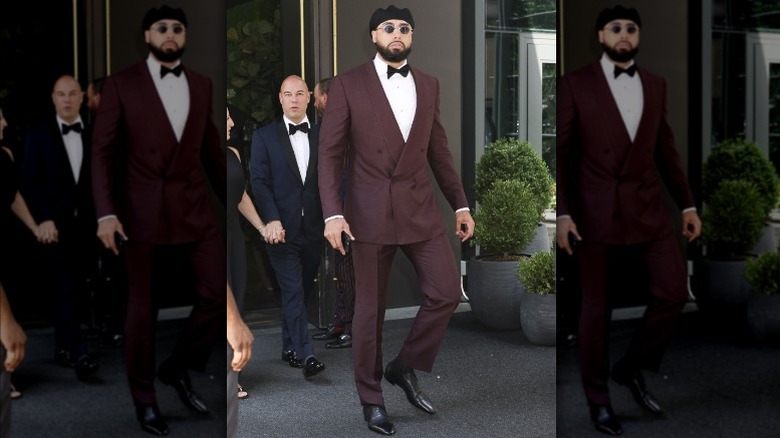 Ross Travis wearing a maroon suit, black bowtie, and beret.
