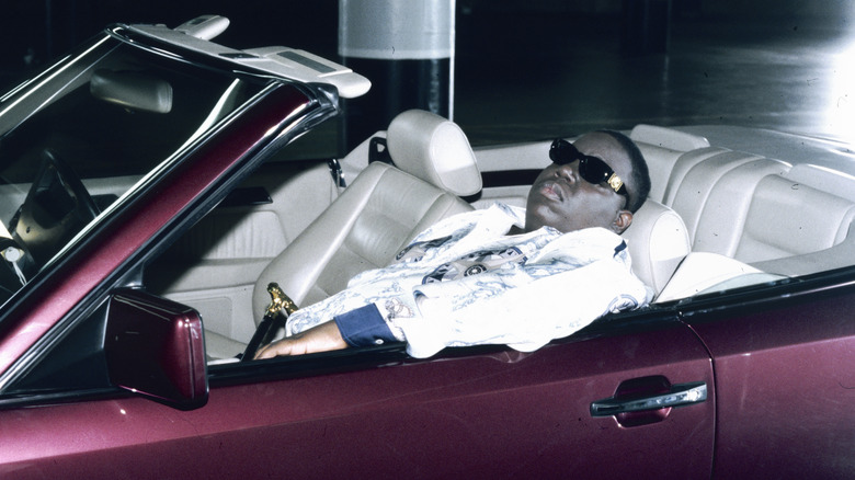 Biggie Smalls sits in convertible
