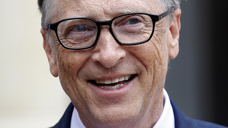 Bill Gates smiles in glasses