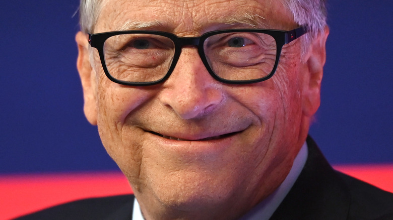 Bill Gates smiles in black-frame glasses