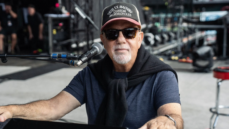 Billy Joel sitting at a piano