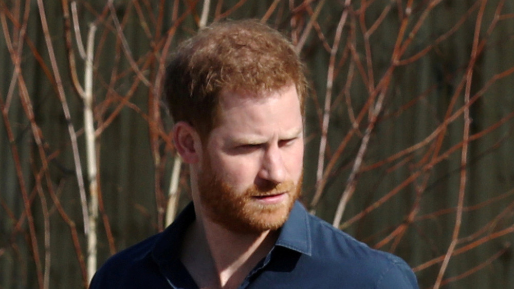 Prince Harry outside and walking