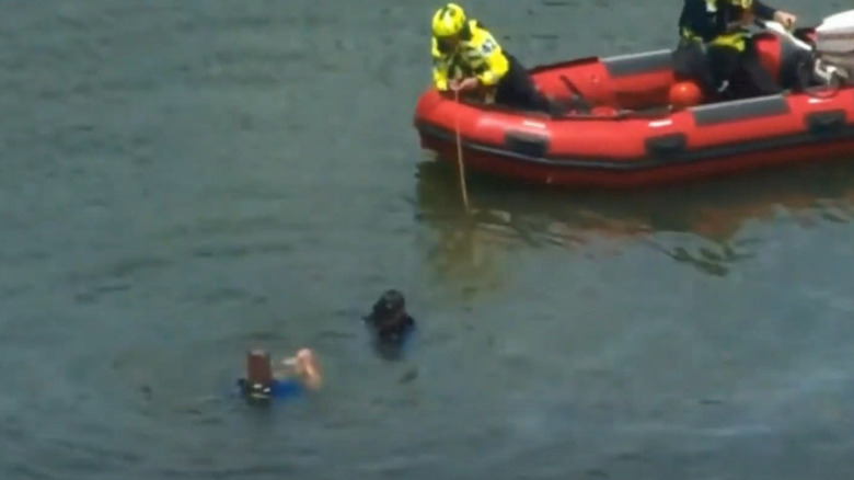 A search team in the water looking for the body of Mallory Beach