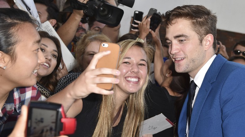 Robert Pattinson taking selfie with fan