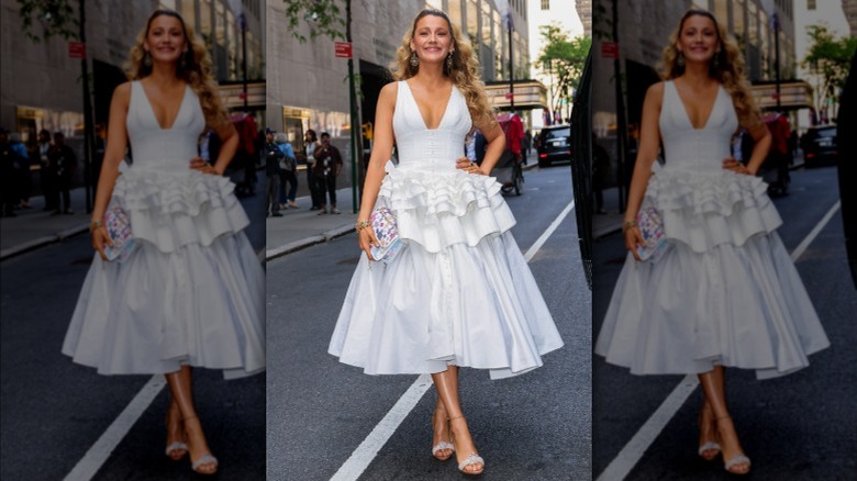 Blake Lively posing in a white dress after arriving outside the "Late Show with Seth Meyers" studio