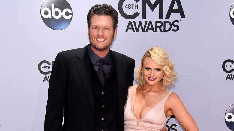 Blake Shelton with hand on Miranda Lambert's waist