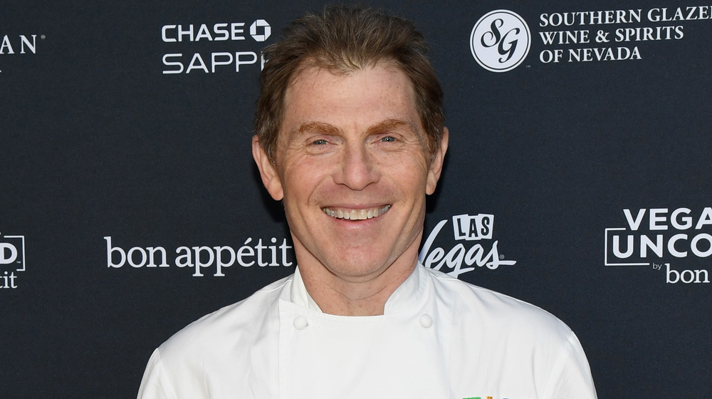 Bobby Flay wearing chef's uniform, smiling