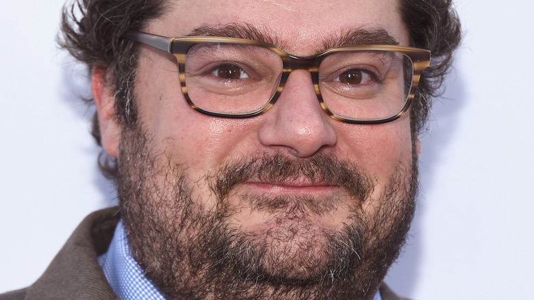 Bobby Moynihan smiles and wears glasses