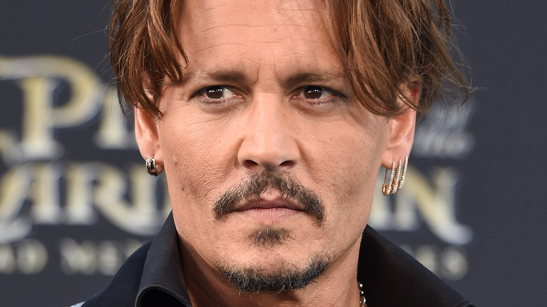 Johnny Depp wearing safety pin earrings