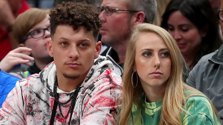 Patrick, Brittany Mahomes with blank expressions