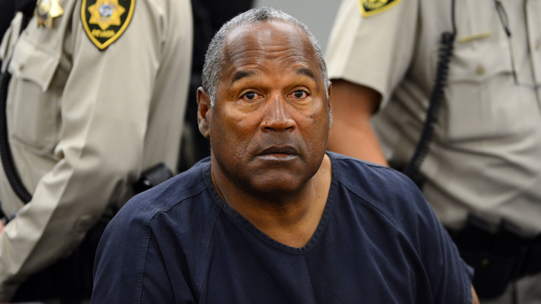O.J. Simpson sitting sits in court