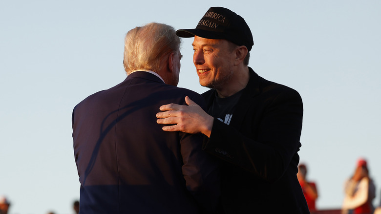 Elon Musk embracing Republican presidential nominee, Donald Trump during a campaign rally at the Butler Farm Show fairgrounds