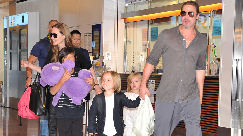 Brad Pitt and Angelina Jolie travelling with their children in happier times