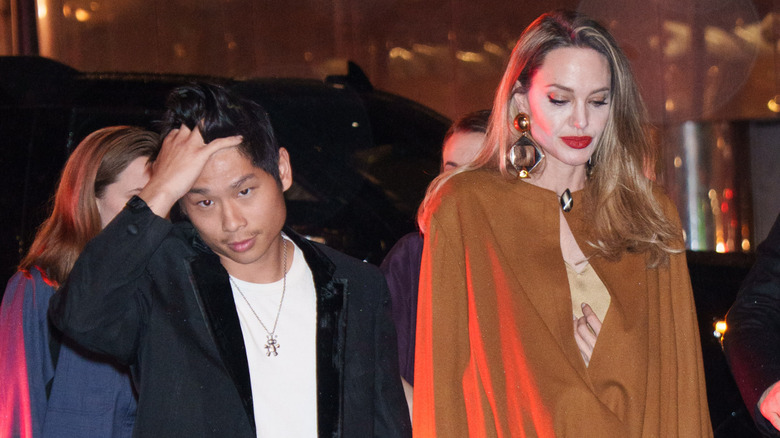 Pax Jolie-Pitt and Angelina Jolie walking together