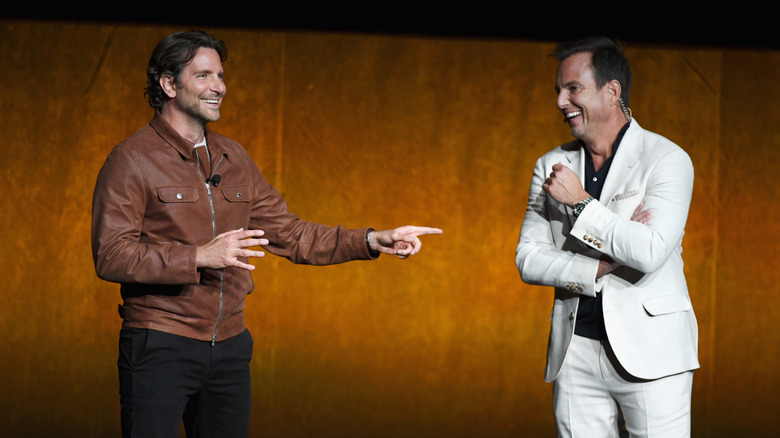 Bradley Cooper and Will Arnett smiling on stage