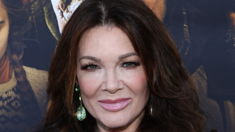 Lisa Vanderpump smiles green earrings