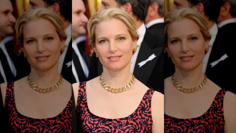 Bridget Fonda in a red dress, posing at an event