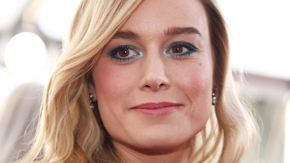 Brie Larson gives a slight smile on the red carpet