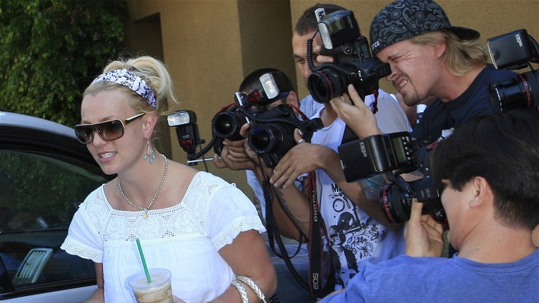 Britney Spears carrying starbucks walks away from crowd of cameras