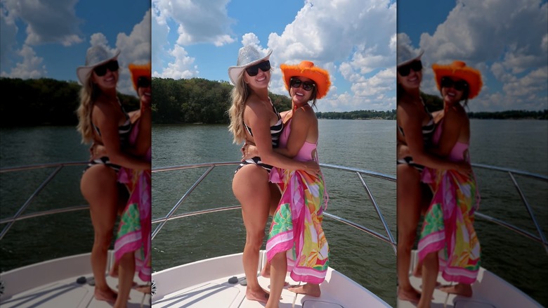 Brittany Mahomes and one party guest posing on a boat