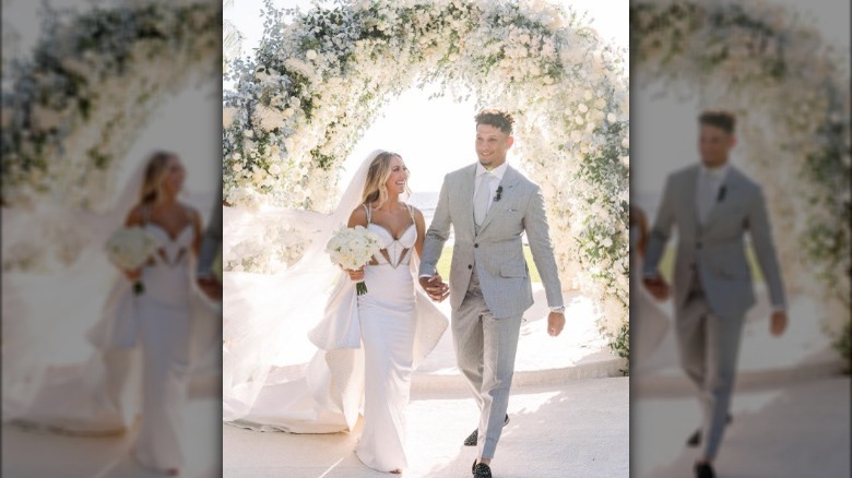 Brittany and Patrick Mahomes holding hands at wedding