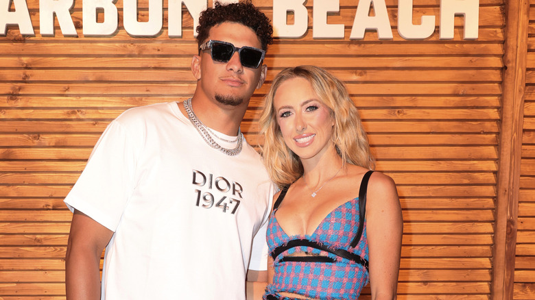 Brittany Mahomes blue dress and Patrick Mahomes wearing sunglasses