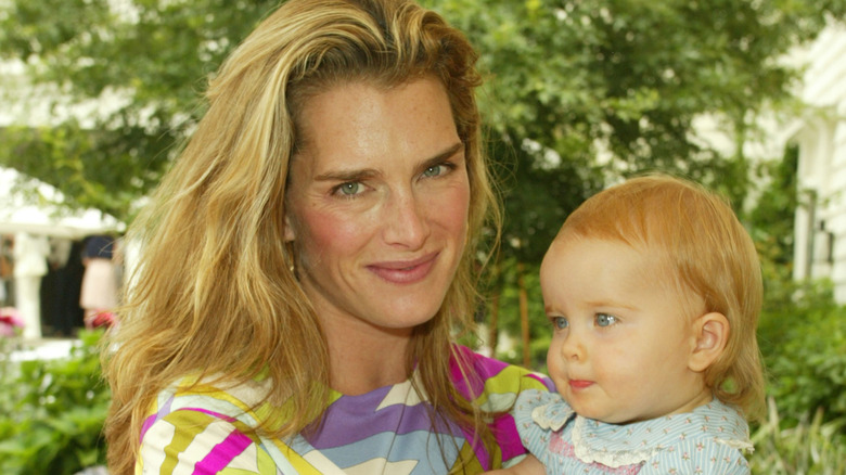 Brooke Shields holding daughter Rowan outdoors when she was a baby.