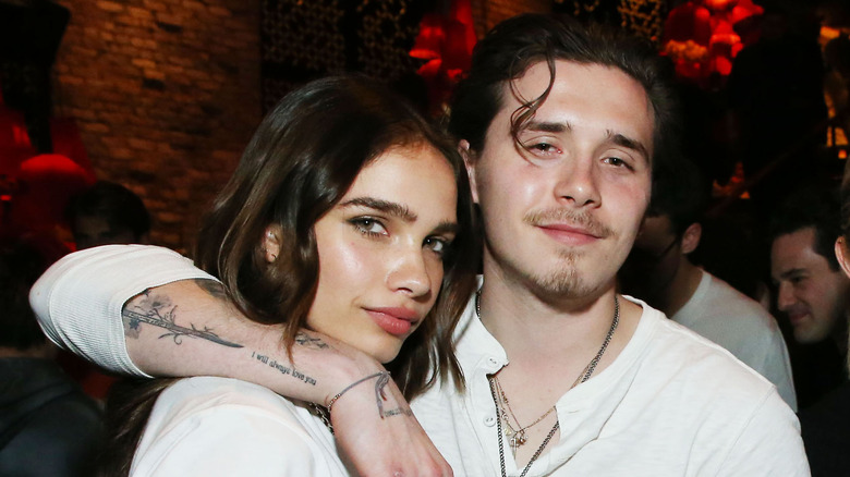 Brooklyn Beckham with arm around Hana Cross