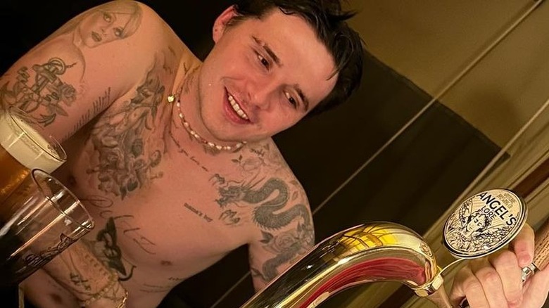 shirtless Brooklyn Beckham smiling