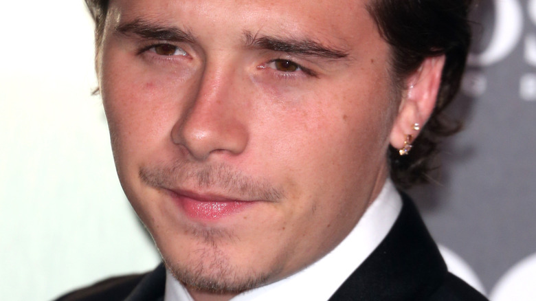 Brooklyn Beckham poses in a tux