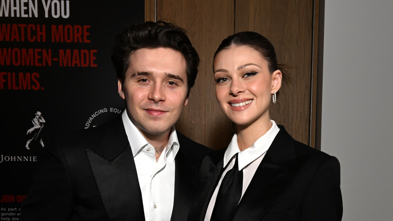 Brooklyn Beckham and Nicola Peltz are all smiles while wearing coordinated monochrome looks.