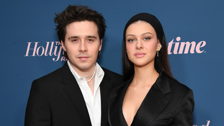 Up-close photo of Brooklyn Peltz Beckham and Nicola Peltz Beckham wearing black jackets at The Hollywood Reporter's Women In Entertainment Gala in 2022