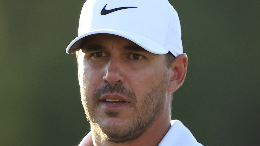 Brooks Koepka wearing a white Nike cap