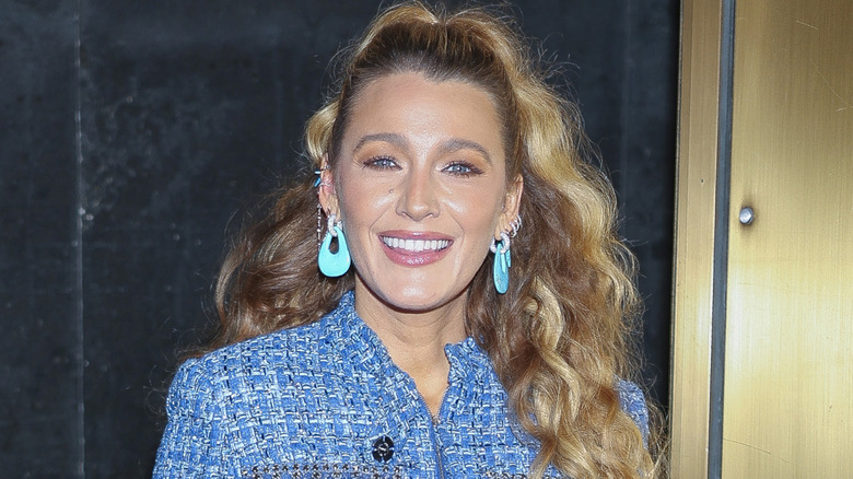 Blake Lively smiling and wearing her hair in a ponytail.