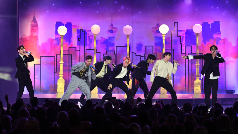 BTS performing "Boy With Luv" with purple background