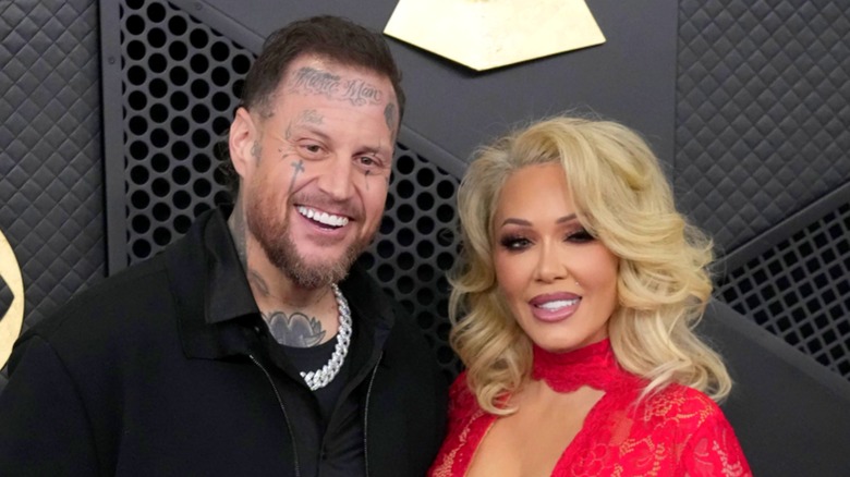 Jelly Roll and Bunnie Xo smiling and posing at an event.