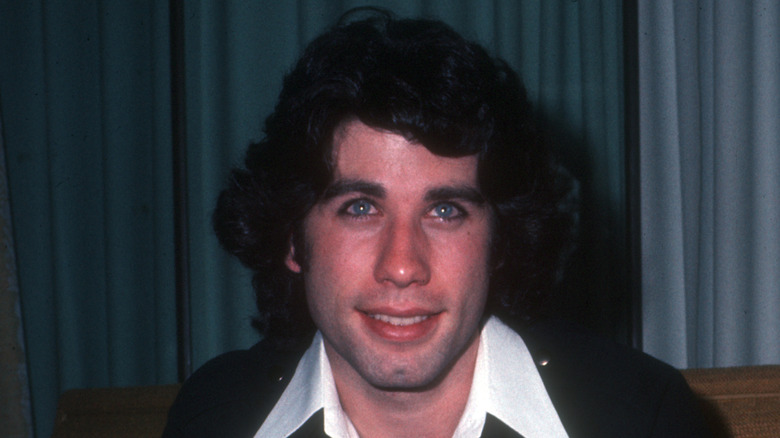 John Travolta smiling for photographers in 1970.