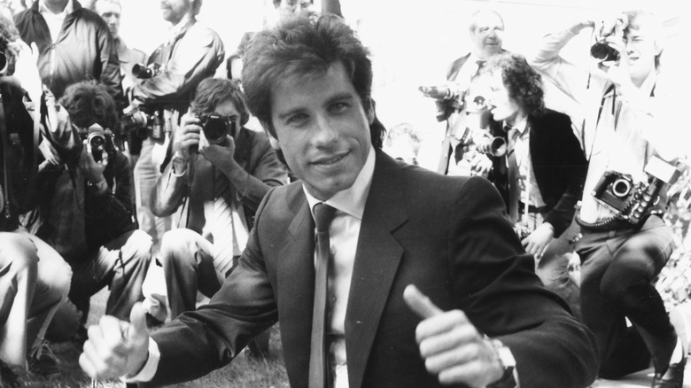 John Travolta giving two thumbs up in the 1980s.