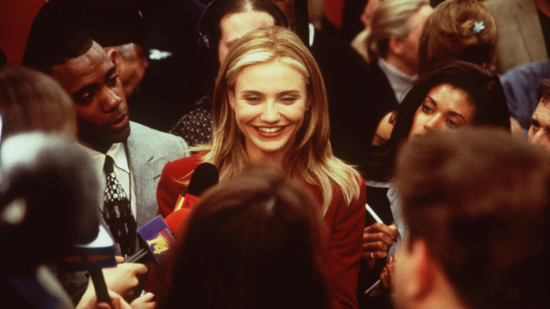 Cameron Diaz surrounded by reporters in a scene from "Any Given Sunday"