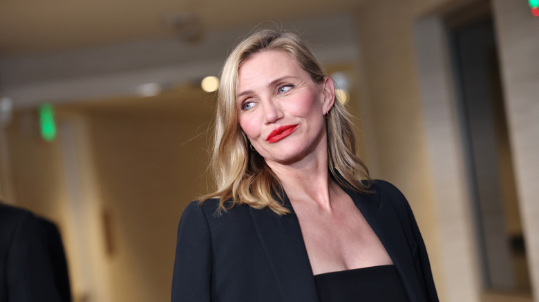 Cameron Diaz wearing red lipstick and a black outfit