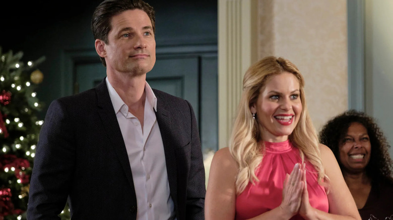Warren Christie and Candace Cameron Bure at party in "If I Only Had Christmas"