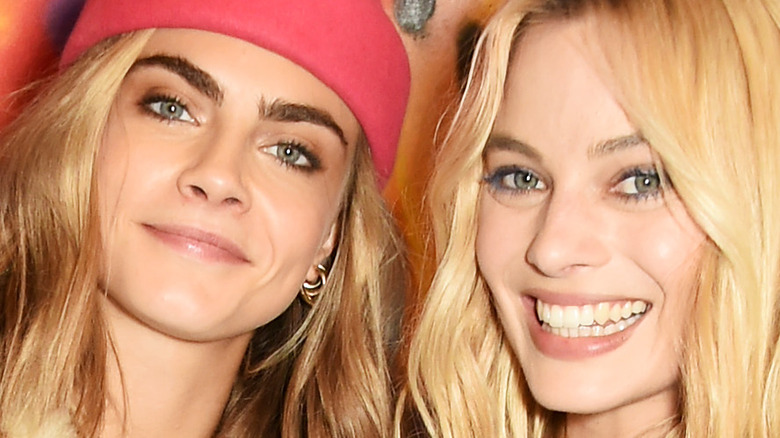 Cara Delevingne and Margot Robbie smiling together