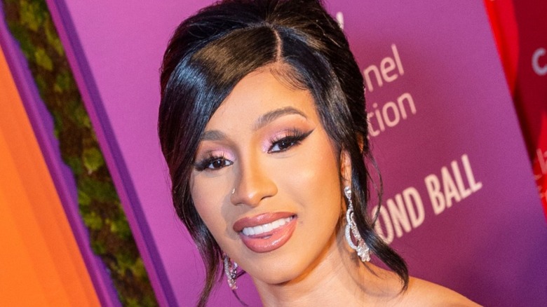 Cardi B smiling and wearing pink eyeshadow 