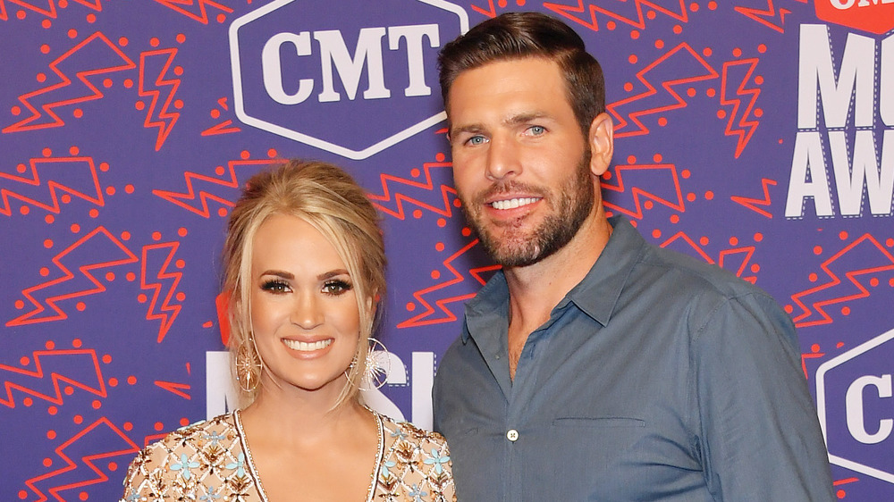 Carrie Underwood and Mike Fisher smiling